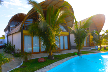 The master bedroom of all our houses looks out on the inviting cool blue waters of the pool